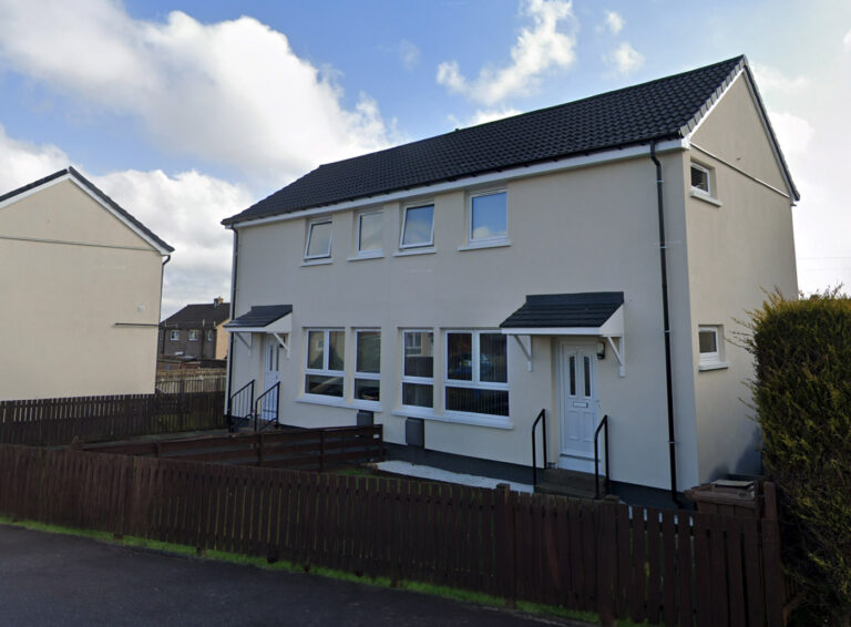 Swedish Timber, Whitburn: pair of rendered semi-detached houses with dark roofs