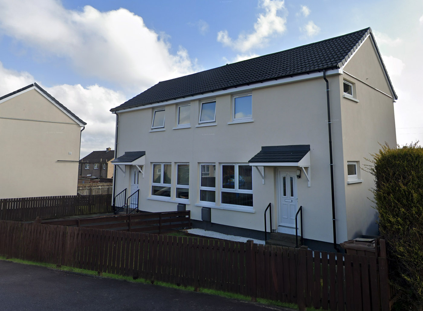 Swedish Timber, Whitburn: pair of rendered semi-detached houses with dark roofs