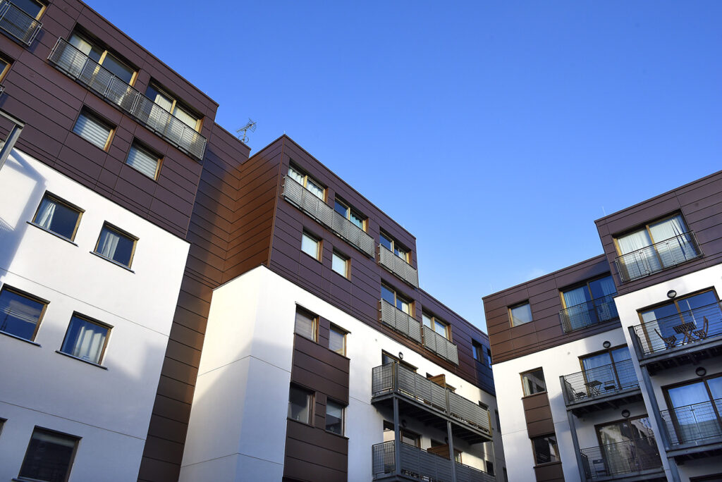 Advent 2 and 3, Manchester: white and brown clad apartment blocks with balconies, seen from below