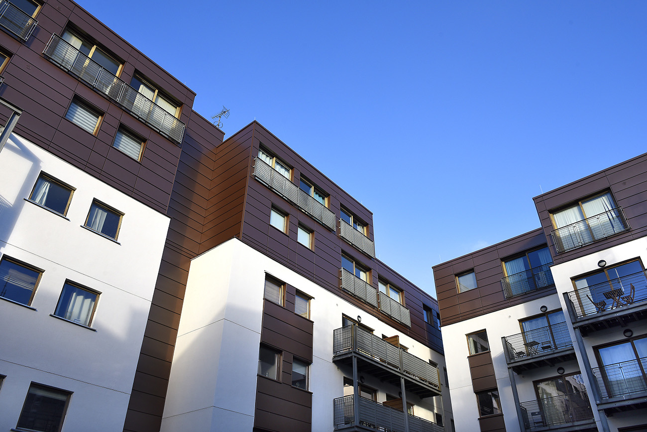 Advent 2 and 3, Manchester: white and brown clad apartment blocks with balconies, seen from below