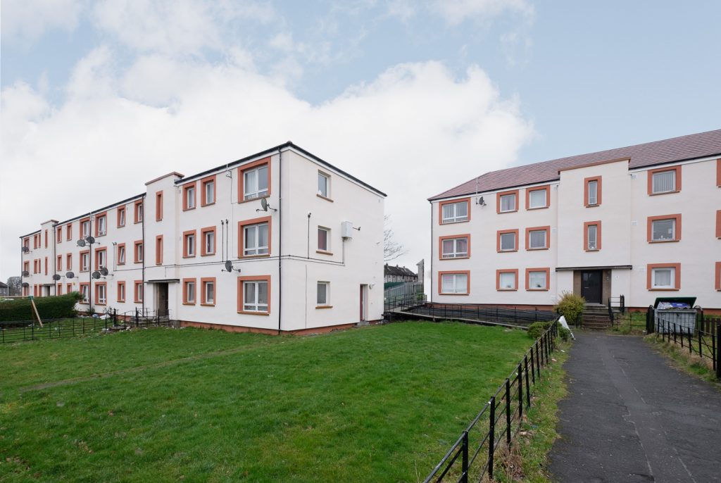 St Mary's, Dundee: white rendered three-storey blocks of flats with red window surrounds