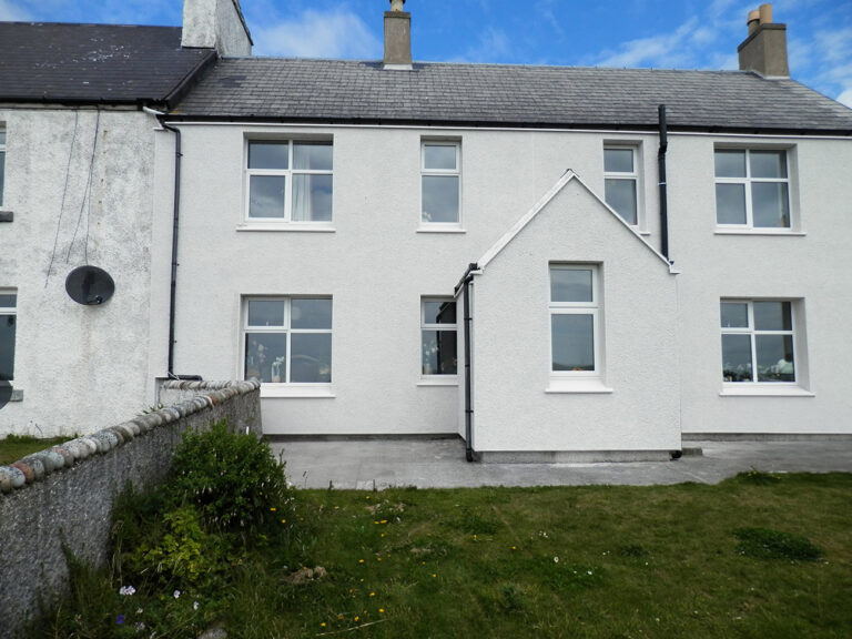 Warmworks: white rendered terraced cottages with a front garden