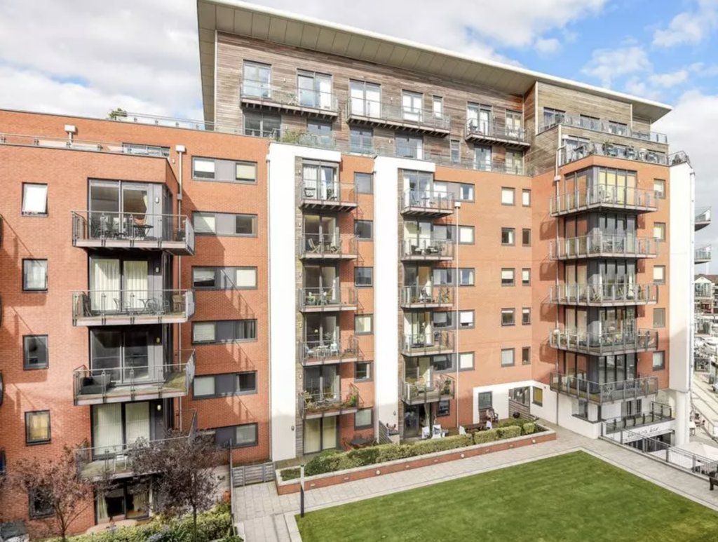 The Blake Building, Southampton: brick and timber-clad residential block with balconies above a landscaped courtyard