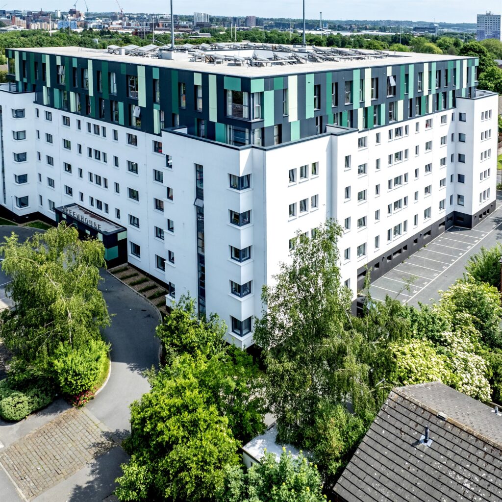 The Greenhouse, Leeds: aerial view of the white and green clad building among trees