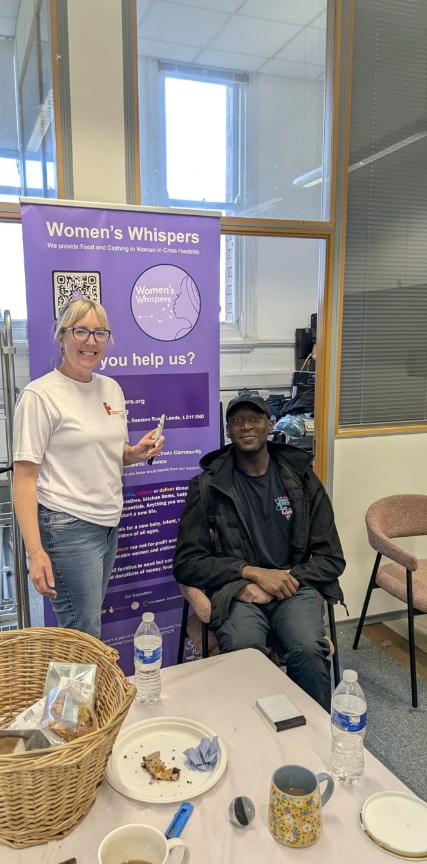 Jenny Kitchen and Lei-vann at Women’s Whispers in Leeds, next to the organisation’s banner
